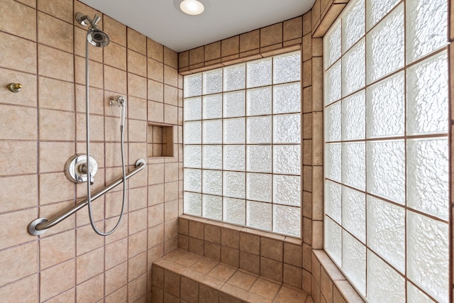 bathroom with tiled shower