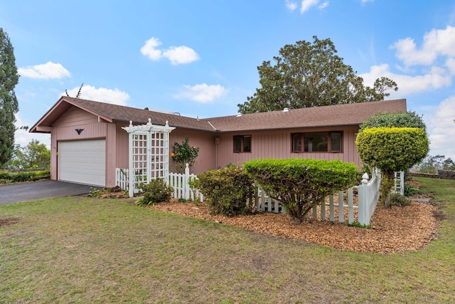 ranch-style home featuring a garage and a front yard