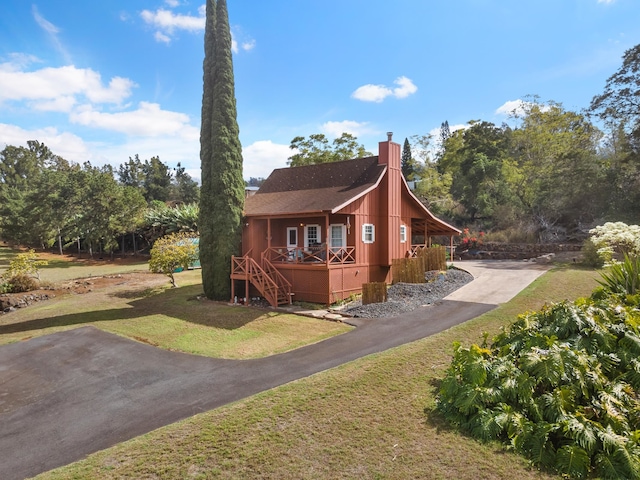 view of property exterior featuring a lawn