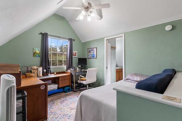 bedroom with ceiling fan, vaulted ceiling, and ensuite bathroom