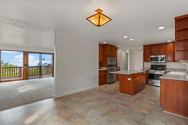 kitchen with appliances with stainless steel finishes, light colored carpet, sink, and a center island