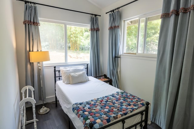 bedroom featuring dark wood-style flooring and vaulted ceiling