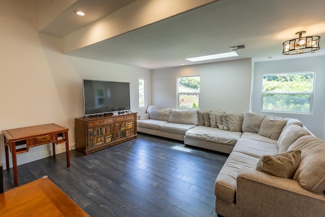 living area with a skylight, visible vents, dark wood finished floors, and recessed lighting