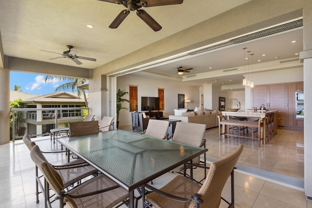 view of patio with ceiling fan, an outdoor living space, and exterior bar