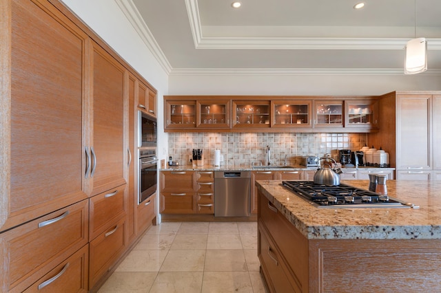 kitchen featuring hanging light fixtures, tasteful backsplash, appliances with stainless steel finishes, and light stone counters