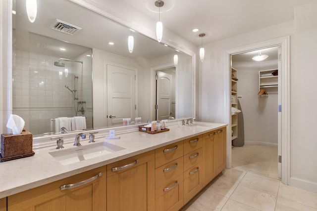 bathroom with a shower with door and vanity