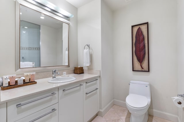 bathroom with vanity, toilet, and tile patterned flooring