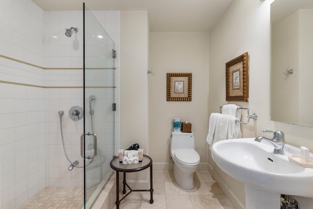 bathroom featuring toilet, tile patterned floors, sink, and a shower with door