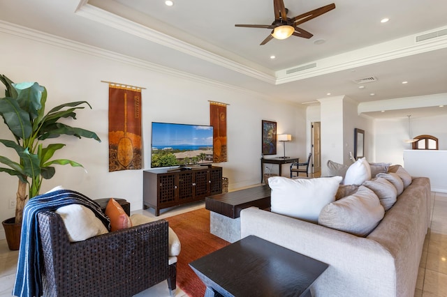 tiled living room featuring a raised ceiling, crown molding, and ceiling fan