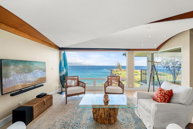 living room with vaulted ceiling, a healthy amount of sunlight, and a water view