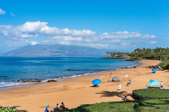 view of water feature featuring a mountain view and a view of the beach