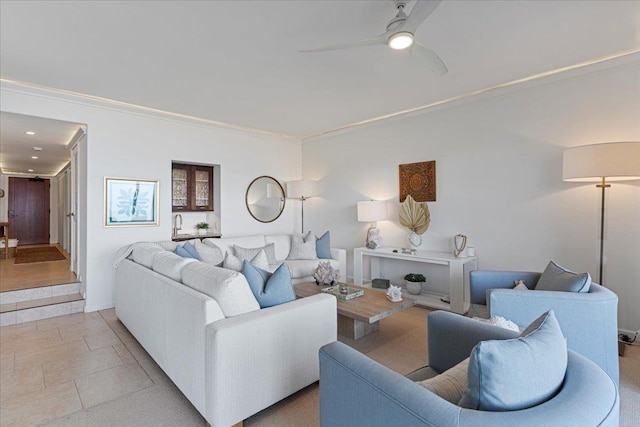 living room featuring ceiling fan and crown molding