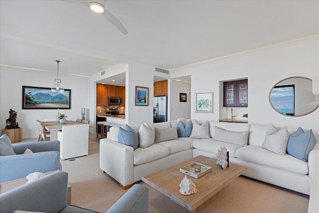 living room featuring crown molding and light carpet