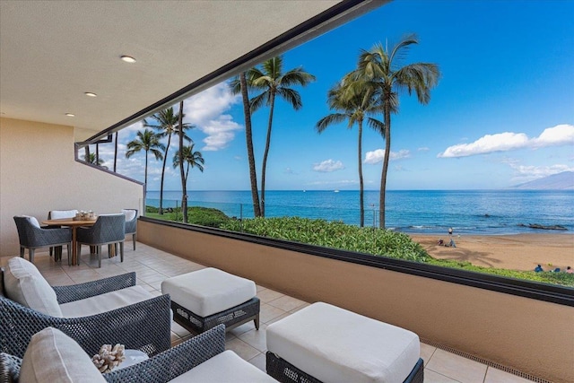 view of patio with a balcony and a water view