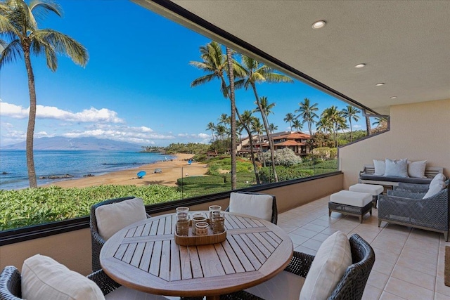 view of patio with a water view and outdoor lounge area