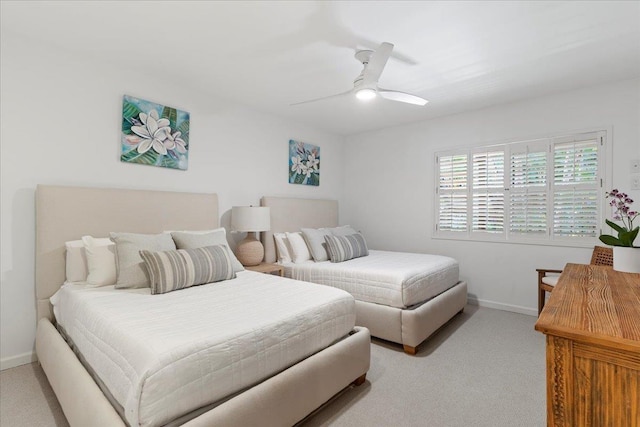 bedroom featuring light carpet and ceiling fan