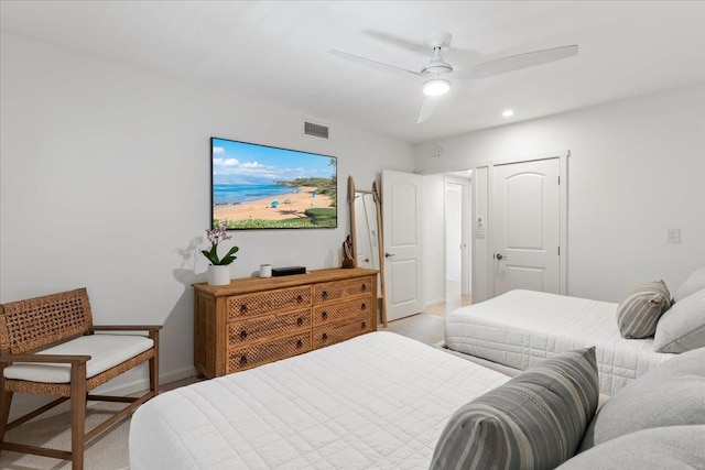 bedroom with ceiling fan and a closet