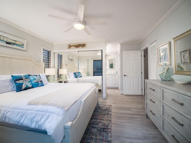 bedroom with light hardwood / wood-style floors, ceiling fan, ornamental molding, and ensuite bathroom