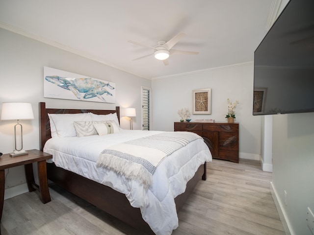 bedroom featuring ceiling fan, light hardwood / wood-style flooring, and ornamental molding