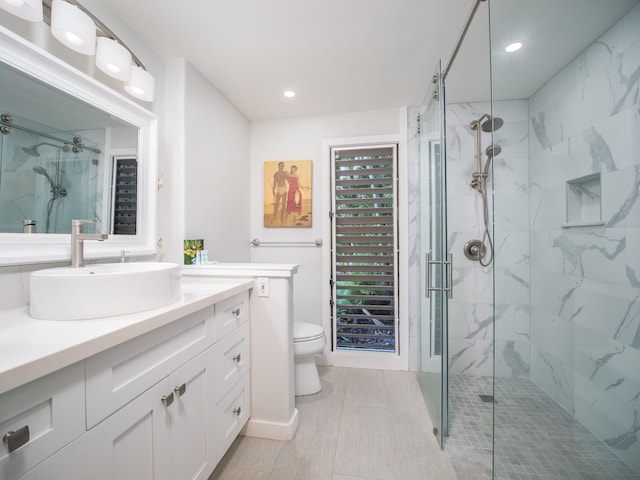 bathroom with vanity, an enclosed shower, and toilet