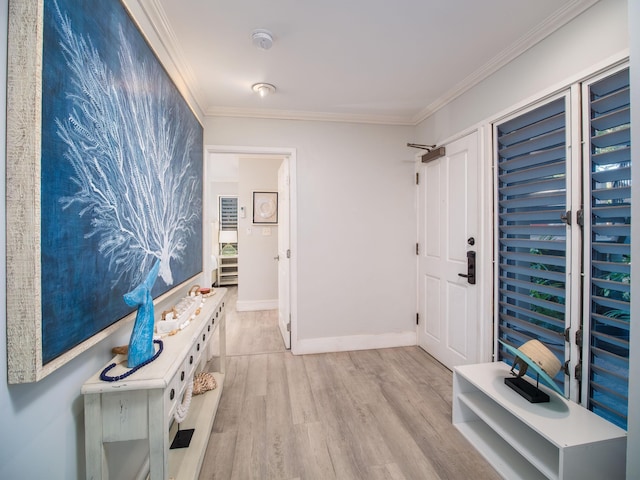 corridor with light hardwood / wood-style flooring and ornamental molding