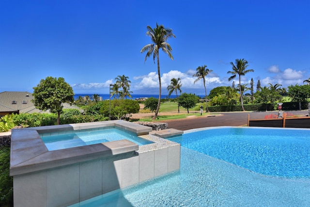 view of pool with an in ground hot tub