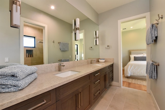 bathroom with vanity, hardwood / wood-style floors, and tiled shower