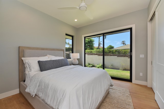 bedroom with a closet, light hardwood / wood-style floors, access to exterior, and ceiling fan