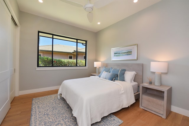 bedroom with a closet, ceiling fan, and light hardwood / wood-style floors