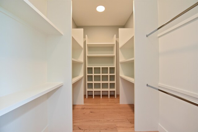 spacious closet with light hardwood / wood-style flooring