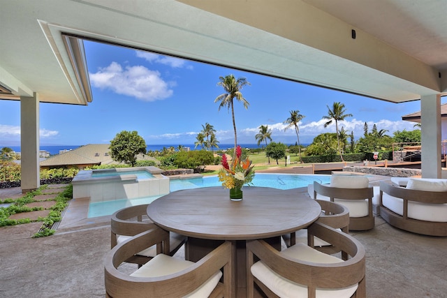 view of patio / terrace featuring a pool with hot tub