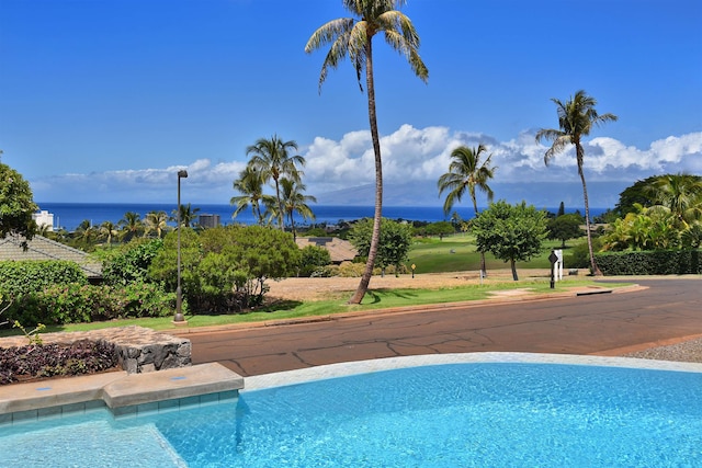 view of pool featuring a water view