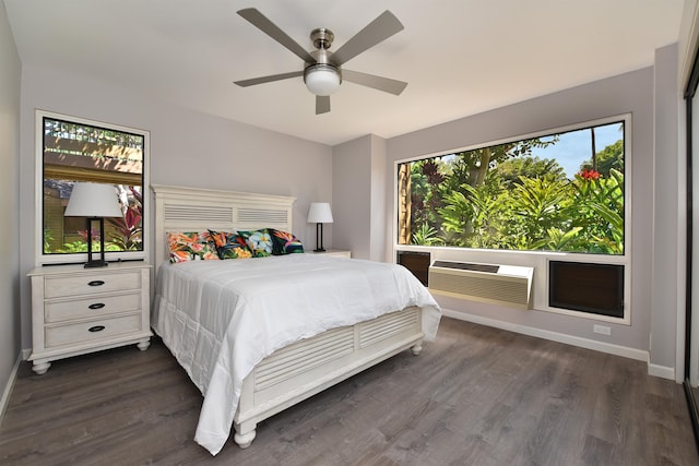 bedroom with dark hardwood / wood-style floors, ceiling fan, and a wall mounted air conditioner