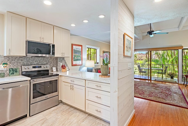 3788 Lower Honoapiilani Rd Unit D101, Lahaina, HI 96761 - kitchen with appliances with stainless steel finishes, recessed lighting, ceiling fan, light countertops, and backsplash