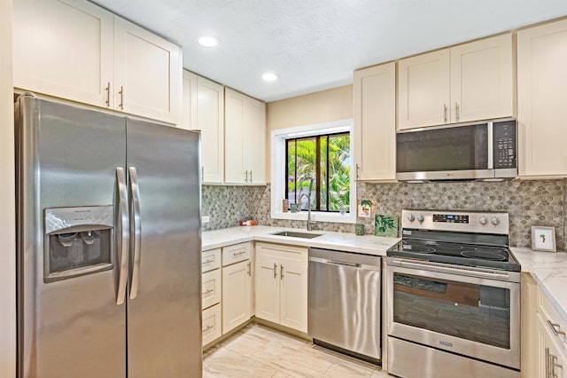 3788 Lower Honoapiilani Rd Unit D101, Lahaina, HI 96761 - kitchen featuring appliances with stainless steel finishes, decorative backsplash, recessed lighting, light stone counters, and a textured ceiling