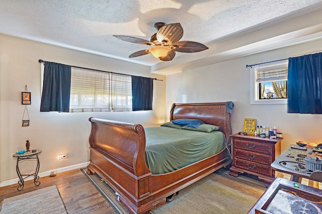 3788 Lower Honoapiilani Rd Unit D101, Lahaina, HI 96761 - bedroom featuring wood finished floors, a textured ceiling, and ceiling fan