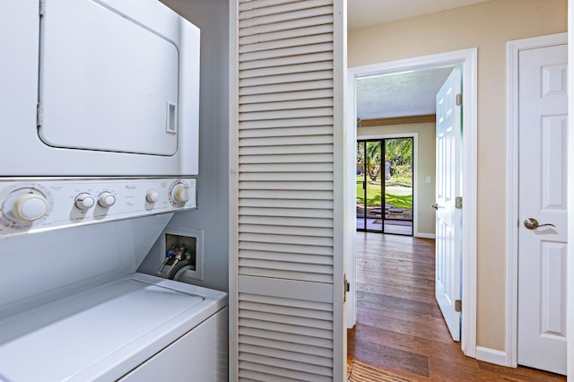 3788 Lower Honoapiilani Rd Unit D101, Lahaina, HI 96761 - washroom featuring stacked washing machine and dryer and wood finished floors