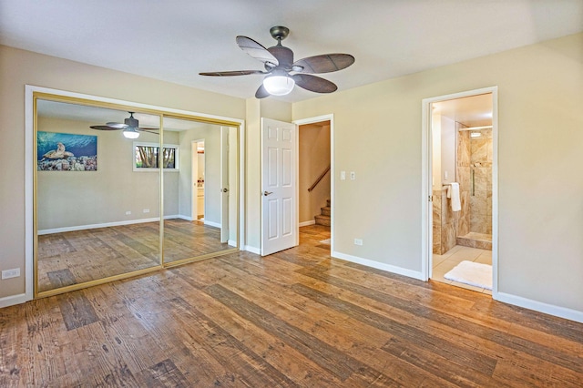 3788 Lower Honoapiilani Rd Unit D101, Lahaina, HI 96761 - unfurnished bedroom featuring wood finished floors, a closet, connected bathroom, and a ceiling fan