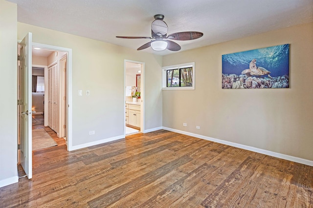 3788 Lower Honoapiilani Rd Unit D101, Lahaina, HI 96761 - unfurnished bedroom with wood finished floors, connected bathroom, and a ceiling fan