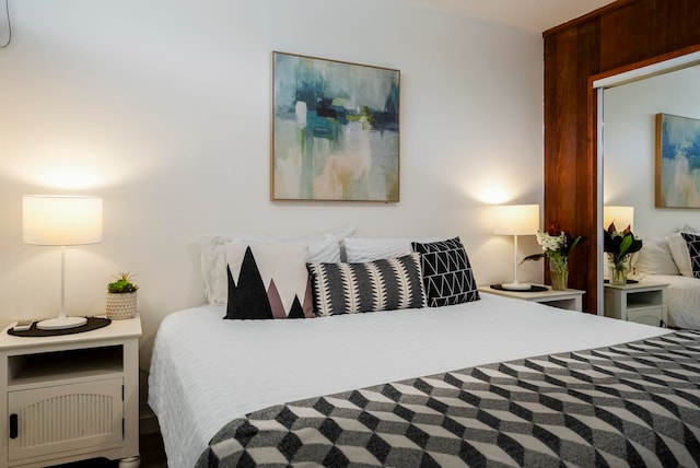 bedroom featuring wooden walls