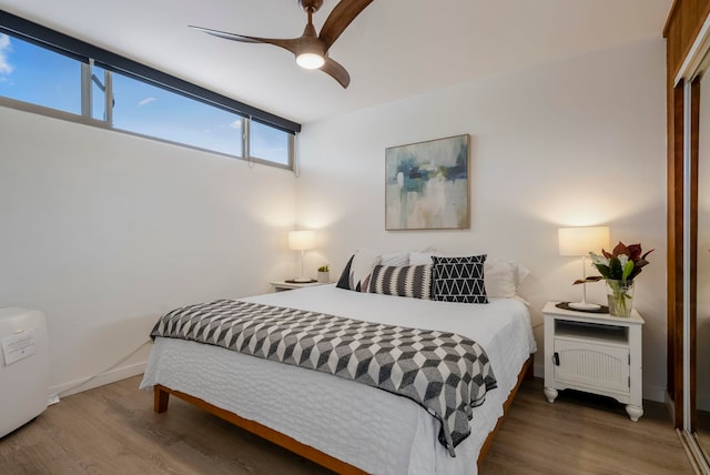 bedroom with ceiling fan and wood-type flooring