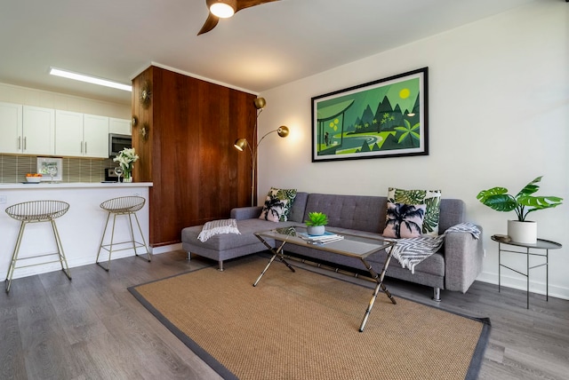 living room featuring dark hardwood / wood-style floors and ceiling fan