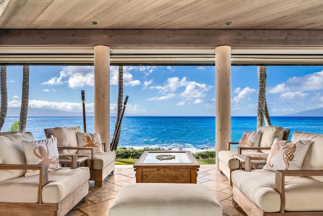 sunroom with beam ceiling, a water view, and wood ceiling