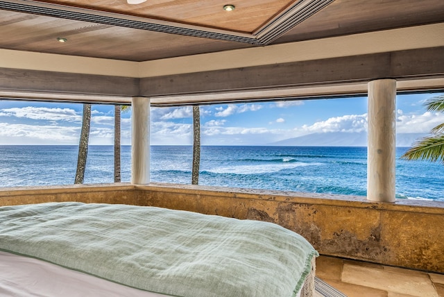 bedroom featuring a beach view, a water view, and wooden ceiling