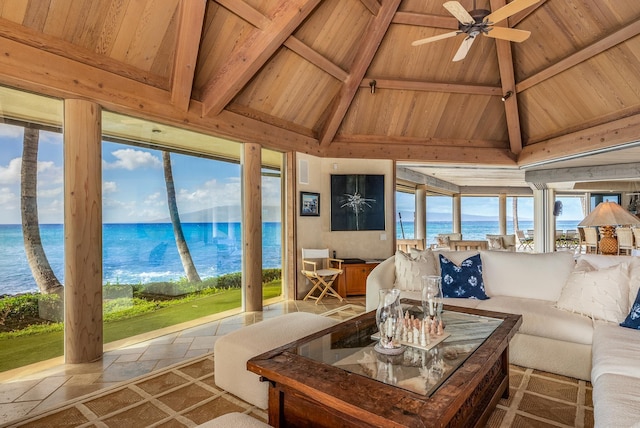 sunroom featuring ceiling fan, lofted ceiling with beams, a water view, and wooden ceiling