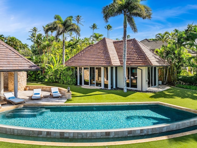 view of swimming pool with a lawn and a patio area