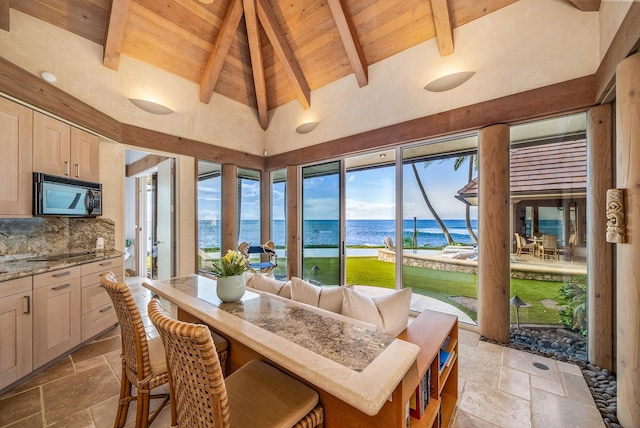 sunroom / solarium featuring lofted ceiling with beams, a water view, and wooden ceiling