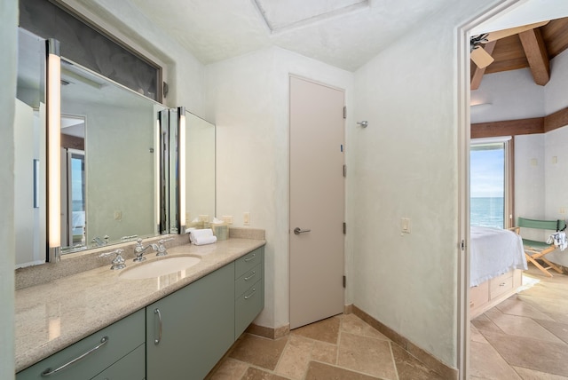 bathroom with beam ceiling, vanity, and a water view