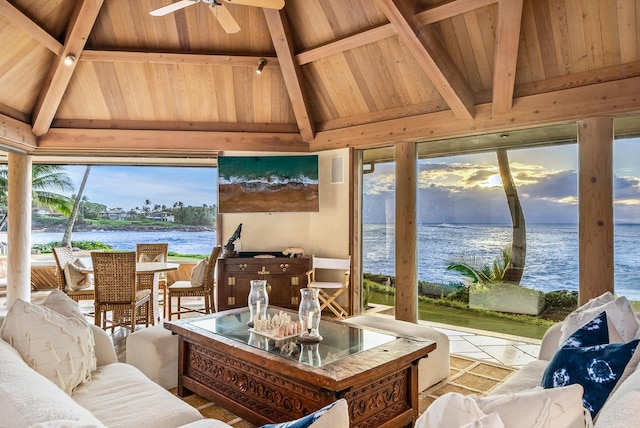 sunroom with vaulted ceiling with beams, a water view, a wealth of natural light, and wooden ceiling