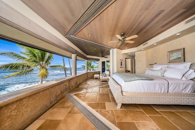 bedroom with ceiling fan, a water view, and wood ceiling